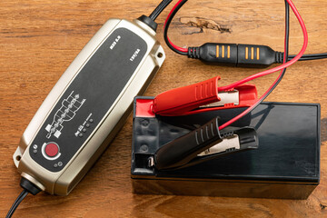 High angle view of battery charger equipment is charging a dry battery.
