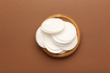 Holder with cotton pads on color background