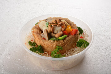 deep fried crispy yam taro ring with stir fried mixed seafood and meat nut in chef oyster sauce...