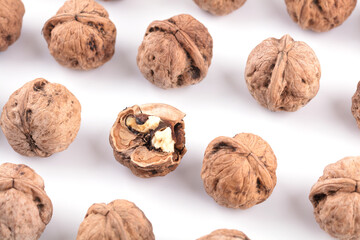 Oily dried walnuts on white background