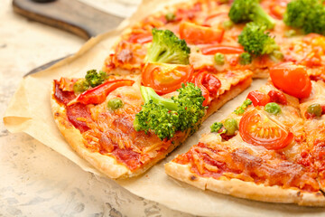 Board with tasty vegetarian pizza on light background, closeup