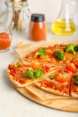 Board with tasty vegetarian pizza on light background, closeup