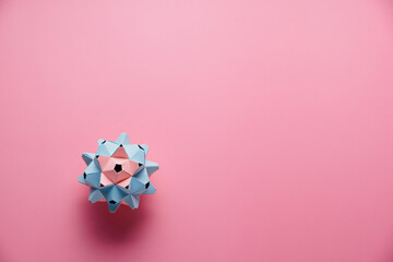 Multicolor handmade modular origami ball or Kusudama Isolated on pink background. Visual art,...