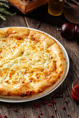 Megrelian khachapuri flat bread with cheese on wooden background