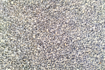Gray gravel pattern texture. Small rocks closeup. Crushed stone surface background