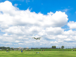 Fototapeta na wymiar 青空とサッカー場と飛行機