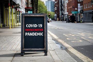Covid-19 Unvaccinated Pandemic. Foldable advertising poster on the street