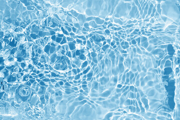 Fototapeta na wymiar Blurred transparent blue colored clear water surface texture. Water waves in sunlight.