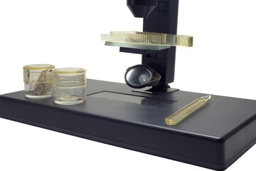 compound microscope with tweezers on slides and dropper and glass jars for specimens on instrument...
