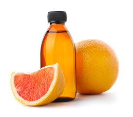 Bottle of essential oil and grapefruits on white background