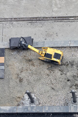 Heavy construction machines outdoors for public place reconstruction.