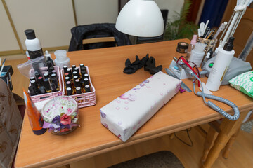 Workplace of a manicurist at home in a pandemic. Close up of antiseptics and nail polishes