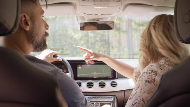 Rear View Of Couple Driving A Car On A Road Trip. Shot With RED Helium Camera In 8K.