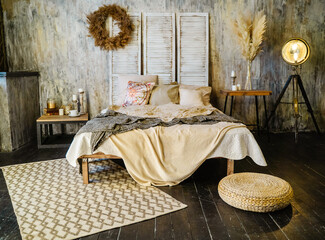 Bedroom interior design with large bed in loft and boho style