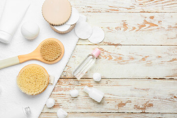 Composition with different massage brushes on light wooden background