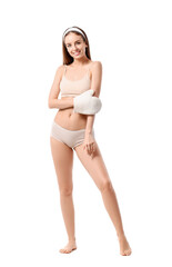 Fototapeta premium Beautiful young woman with massage mitten on white background