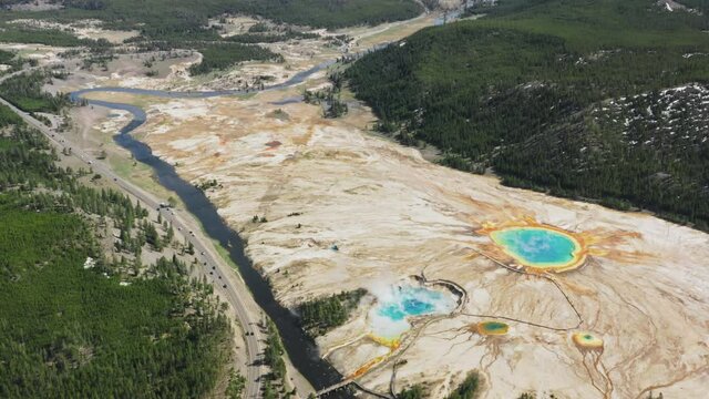 Aerial view of Yellowstone midway geyser basin rich of hot minerals water in vibrant colorful lakes. Yellowstone National Park Grand Prismatic Spring, Wyoming USA 4K footage cinematic landscape view