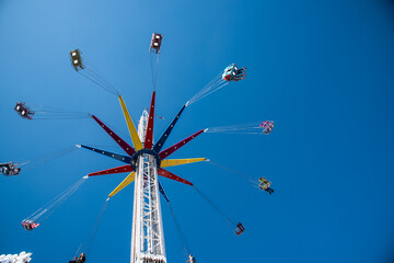 Den Helder, Nederland. 7 July 2021. Carousel at the fair with blue background.