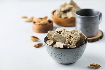 Halva slices in a bowls. Oriental sweetness. Copy space.