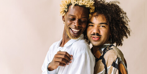 Beautiful gay couple standing in a studio - obrazy, fototapety, plakaty