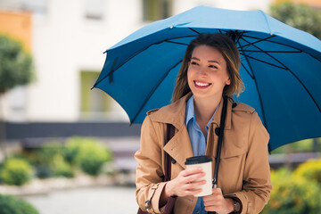 Stunning lady under blue umbrella