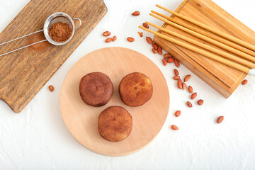 Board with tasty cacao mochi on white background