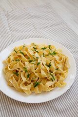 Homemade One Pot Garlic Parmesan Pasta with Parsley, side view. Copy space.