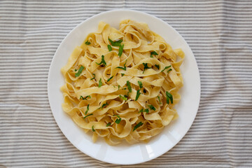 Homemade One Pot Garlic Parmesan Pasta with Parsley, overhead view. Flat lay, from above, top view.