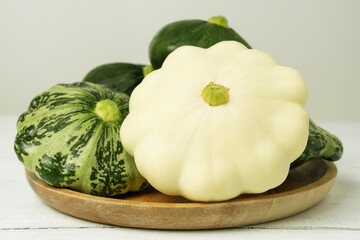 Green and white pattypan squashes on the table. Fresh diet vegetables.