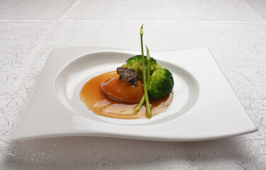 braised single whole big abalone seafood with vegetable and black truffle , ginseng in chef oyster sauce asian premium halal menu
