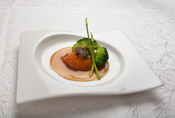 braised single whole big abalone seafood with vegetable and black truffle , ginseng in chef oyster sauce asian premium halal menu