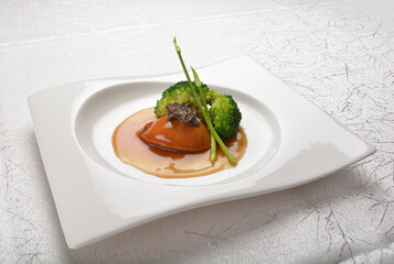 braised single whole big abalone seafood with vegetable and black truffle , ginseng in chef oyster sauce asian premium halal menu
