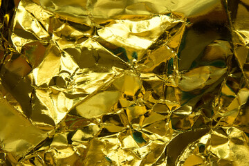Crumpled yellow gold paper texture.