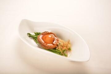 braised single whole big abalone seafood with vegetable and black truffle , ginseng in chef oyster sauce asian premium halal menu