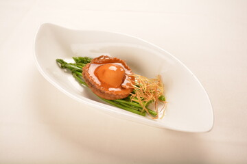 braised single whole big abalone seafood with vegetable and black truffle , ginseng in chef oyster sauce asian premium halal menu