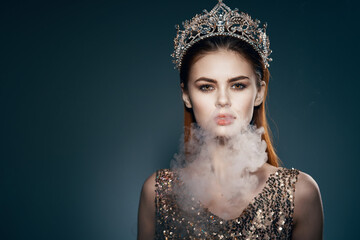 woman with a crown on her head smoke from the mouth Glamor luxury dark background