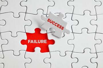 The words failure and success on missing puzzle pieces.