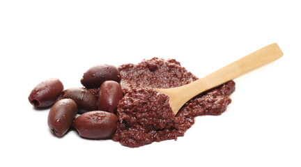 Olive (Kalamon) spread in oil with olives and wooden spoon isolated on white background