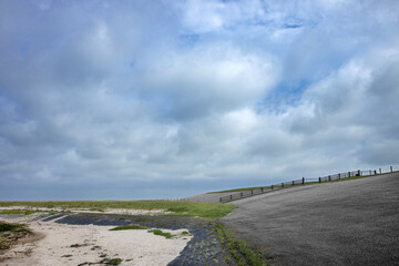 Dike at Waddenzee coast Moddergat Paesens Friesland Netherlands. Unesco world heritage. Clouds and skies.