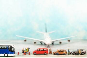 Air travel concept with miniature travelers