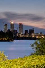 A colorful night cityscape of a modern residential district. Highrise buildings in the background.