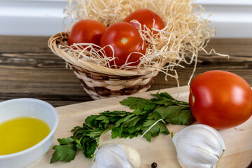 Tomatoes on the table and in the basket, olive oil and balsamic vinegar, garlic, vegetables, vegetarianism, healthy eating