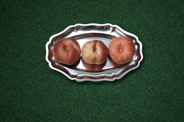 The flat peach (Prunus persica var. platycarpa), also known as the doughnut peach or Saturn peach,...