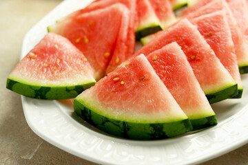 Seedless watermelon slices on a plate. Delicious summer foods, healthy snack.