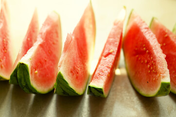 Summer foods background. Ripe watermelon slices in a plate, on warm background