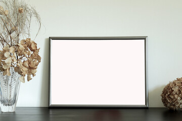 Fototapeta na wymiar empty frame with dry flowers, mockup for photography