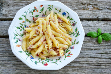  Italian home made   penne pasta  with  tuna  fish, parmesan cheese and black pepper .