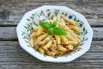  Italian home made   penne pasta  with  tuna  fish, parmesan cheese and black pepper .