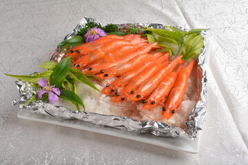 flaming bbq grilled big fresh tiger prawn seafood with salt ice on bottom asian halal menu