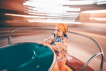 Little girl on the roundabout.